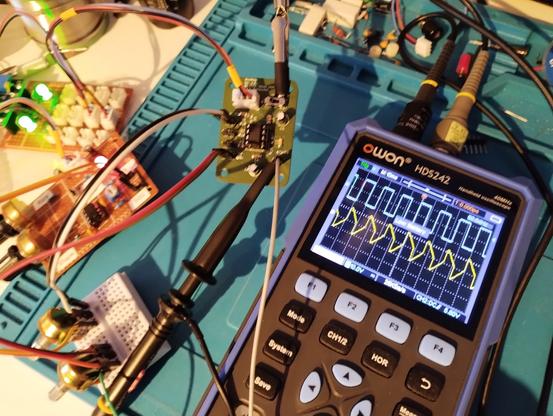 photo of my test setup. the oscilloscope shows the square wave input and the resulting output after mixing it with a triangle wave.