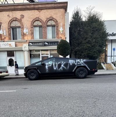 Photo by Courtney Heard on February 12, 2025. May be an image of 1 person, car and text that says 'ሸሲሰ nobu SUSHI DENT FUCK mUsk .K'.