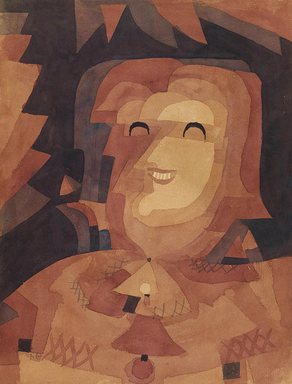 An Expressionist painting with aspects of Cubism. A variety of overlapping shapes in yellow and orange form a picture of a woman, who is simultaneously in profile and en face. Her eyes and mouth are cartoonishly drawn and are prominent by their incongruity.