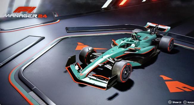 Screenshot of a Formula 1 car in a showroom in the F1 Manager 24 game. The car has a custom livery in the colors of the Asticassia School of Technology from The Witch from Mercury: grey-green and black with red highlights.