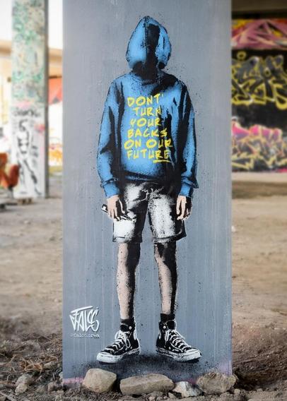Streetart. A mural of a somewhat confused young man has been spray-painted on a gray concrete pillar. The boy is standing there in white shorts, sneakers and a blue hoodie, his arms hanging down. He is holding a crayon in his hand. "Don't Turn Your Backs on our Future" is written in yellow letters on his blue sweater. He probably wrote the text on it. However, he has the hoodie on backwards and the hood is over his face.
The Artist:
"For a dismissed generation refusing to accept a predetermined future that has already been written for them..."
