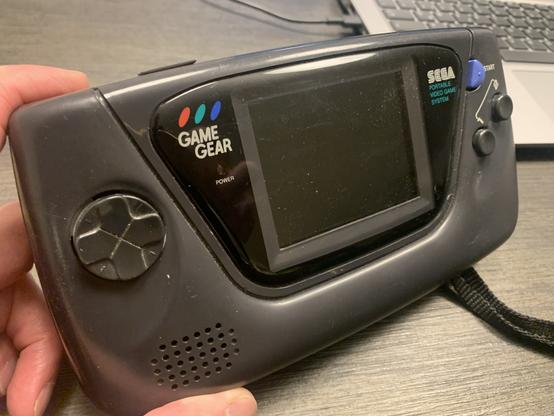 An all black SEGA GameGear handheld console.