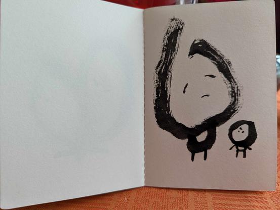 Petit cahier brut avec une série de dessins intuitifs et spontanés dessinés au feutre pinceau noir.