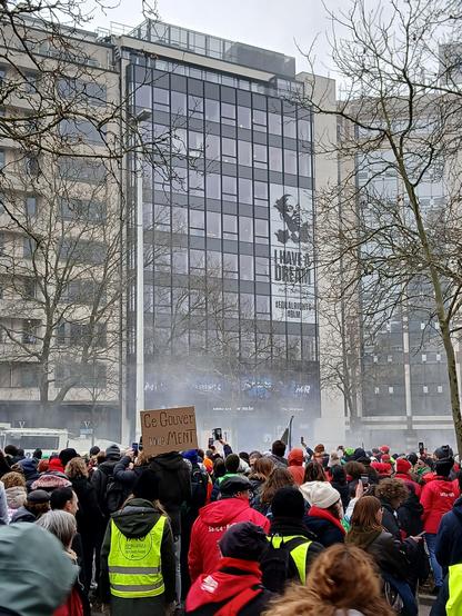 Foule devant le siège du parti politique du mr, avec du gaz lacrymo