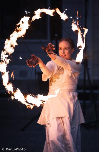 A woman dancing with torches.