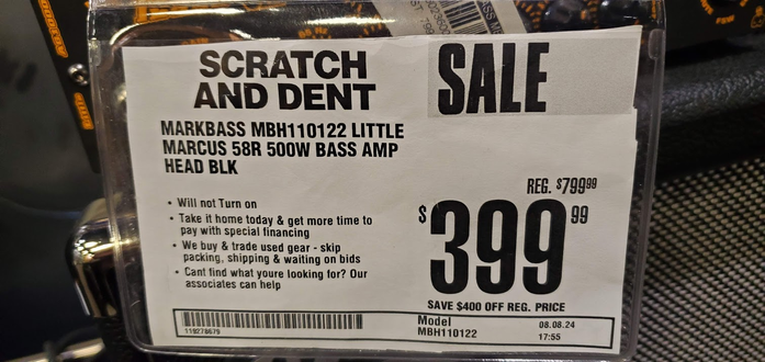 "Scratch and dent" sale tag from a Guitar Center for a MarkBass bass amplifier head. On sale for $399 instead of regular $799 but the first bullet in the description says "will not turn on"