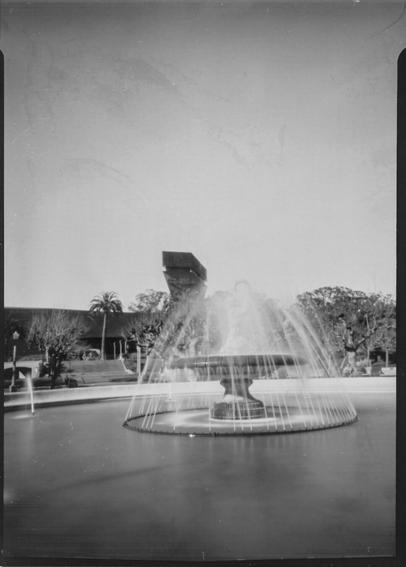 A black and white pinhole photo of a fountain in the music concourse in front of the De Young museum