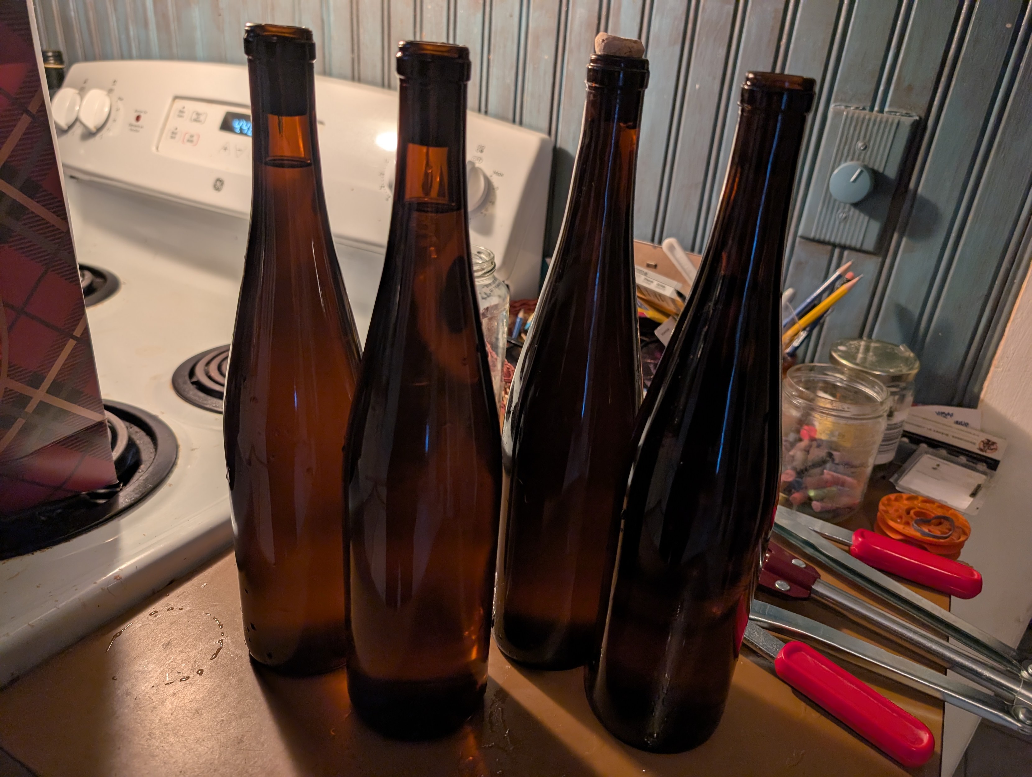 Four amber wine bottles