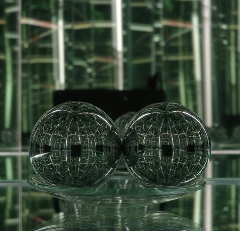 A pair of steel balls on a watch glass and the camera between six mirrors
The photo is cropped but not further edited.