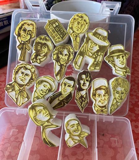 Same box, open, showing the carve side of fifteen stamps with the faces of Doctor Who (and one police box)