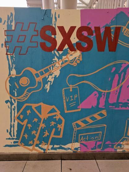 A painted sign with "#SXSW" in the Austin Convention Center during the 2018 edition of the conference.