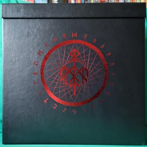 Front view of the "Runaljod Trilogy Vinyl Deluxe Boxset": Black faux leather box, with a magnet fixated lid on the top and runic artwork in red silverfoil printing.