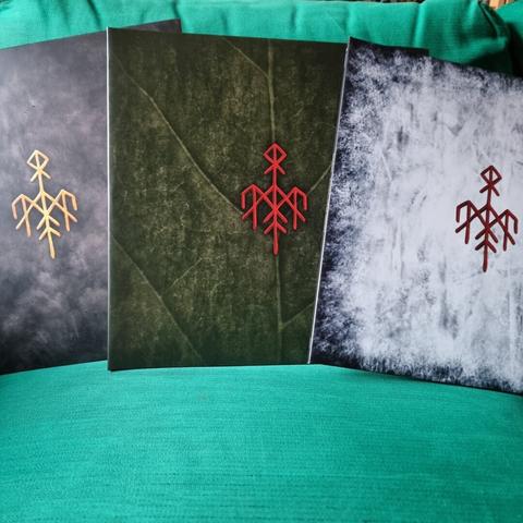 All three albums shown withouttheir slip cover:
- "Gap Var Ginnunga" is white with some bluish-black pattern that is stronger on the borders and less so on the middle, making it look "snow like". The Band logo is printed in the middle in red
- "Yggdrasil" has a dark green cover artwork that is made up to look like a macroscopic image of a leaf of a tree. It has a bright red bandlogo in the middel.
- "Ragnarok" has a grayish makeup, that looks like smoke. The middle shows the band logo in gold.