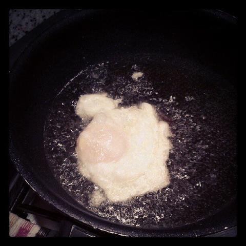 An egg being fried on a pan