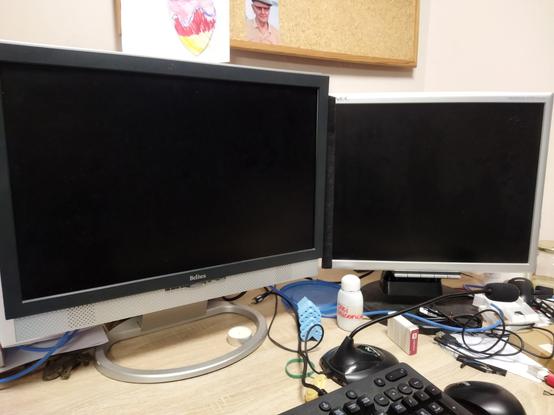 Two old monitors on a desk top.