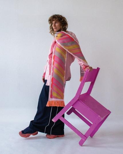 another studio photo featuring Robin Rosbak, he's wearing the blue scarf while standing on the old LCD tv, he's wearing the pink shoes & a pants from korean brand; thug club.