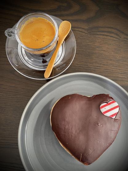 A shot of espresso paired with a (heart-shaped) Boston Cream Doughnut.