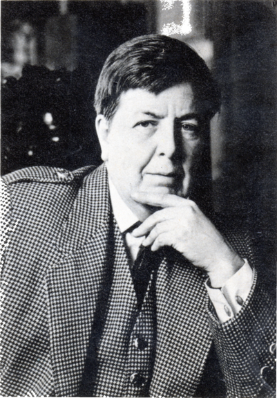 Black and white photo of Nicholas Stuart Gray, a man with short dark hair, wearing a checkered three-piece suit and posing with his hand on his chin.