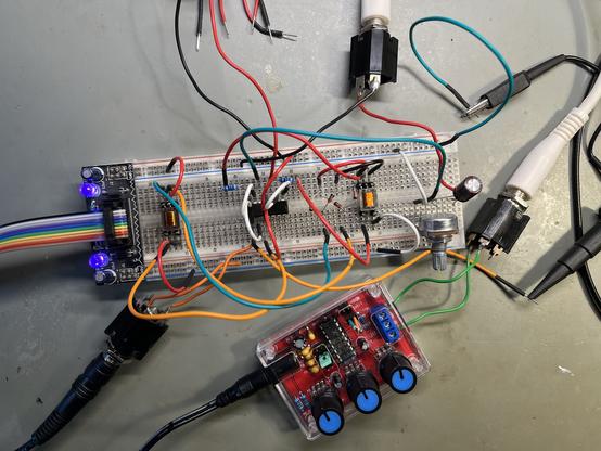 Breadboard with audio transformers, opamp, diodes and sine wave generator