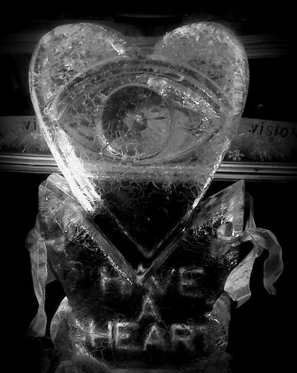 A valentine heart carved in ice with an open eye in the center. Inscribed on the base: HAVE A HEART