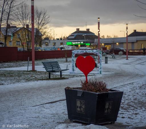 A wooden heart in a park.