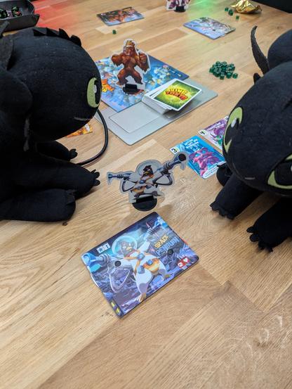 Twothless sitting around a board game