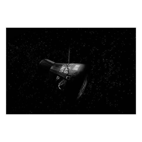 a diorama of a space capsule floating in darkness