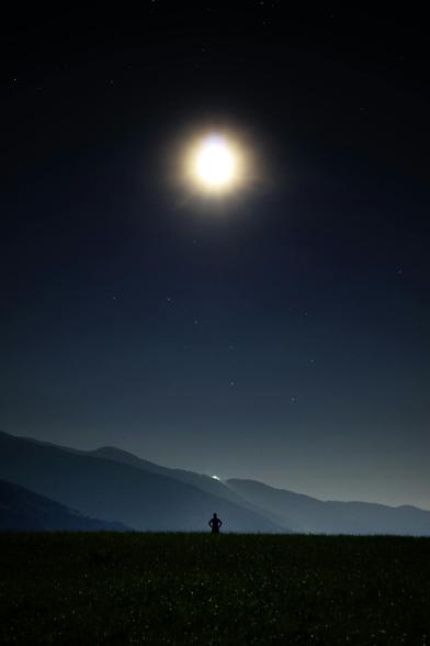 Pexels & Pixabay image of a very bright moon above an eerie mountainous landscape. It is a dark night with a few pinpoint stars visible in the sky. Way down below is a black silhouette of a figure looking out over the world, the mountains, the sky, and the Moon and stars. 
Captioned, "Silhouette of Person in Green Grass Under the Sun during Daytime" 

Brixen, Trentino-Alto Adige, Italy
Dated 2016 Jan 11, by Pixabay. 
www.Pexels.com/photo/silhouette-of-person-in-green-grass-under-the-sun-during-daytime-33696/ 

www.KronoMoon.org 🏳️‍🌈 ☮️ 
#KronoWatch