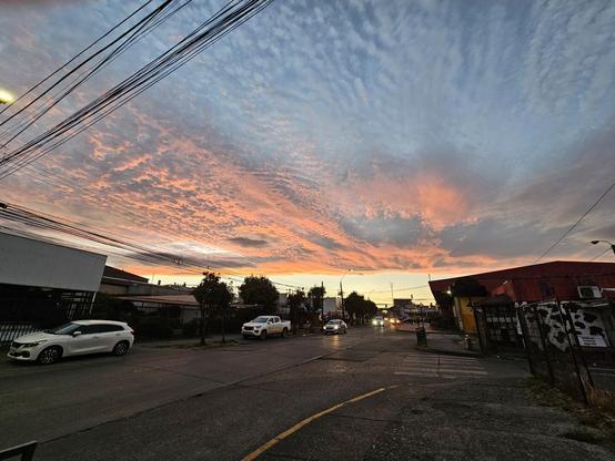A picture showing a sunset in Osorno, Chile. The tones are golden and red as in fire.