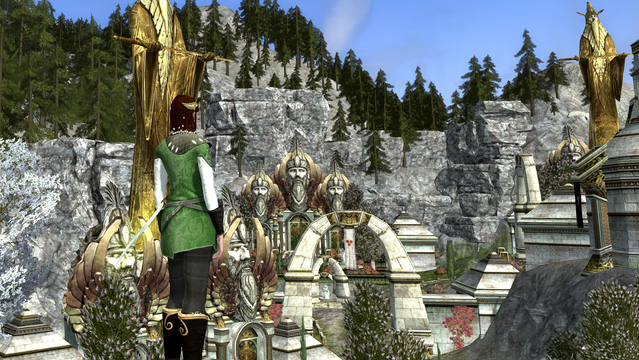 My female human LOTRO character looking down on a Gondorian Town of white stone arches, immense golden statues and stone-carved heads of man. Note: no female heads.