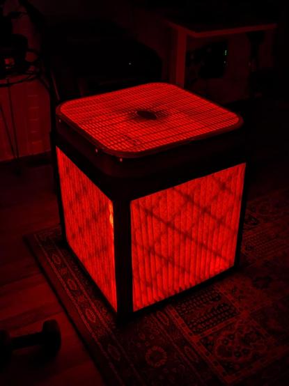 An Corsi-Rosenthal box illuminated with a red light from within