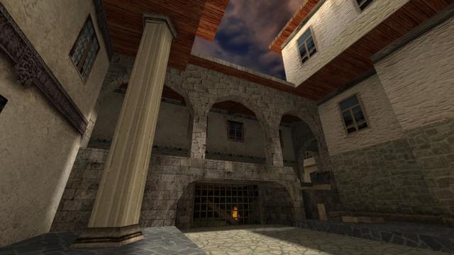 In this picture you can see an underpass. Which connects into one courtyard with another. But there is also a broken staircase. To the left of this and under the underpass is a large metal fence. Behind it a large wooden beam is burning. This is on the map de_torn in the game Counter-Strike 1.6.