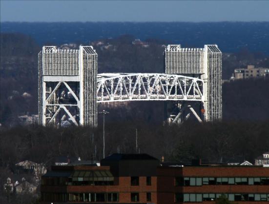 The Fore River Bridge, a vertical lift bridge, in the raised position, photographed from Buck Hill.