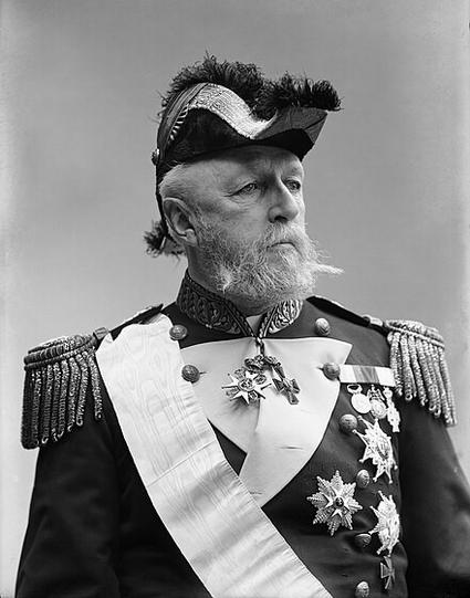 An elderly man with a white beard looks stately in an official uniform and tricorn hat. King Oscar II of Sweden and Norway.
Lars Larsson, public domain.