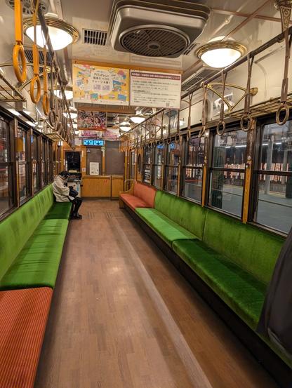 the interior of an old timey brown train cart, operating in kyoto