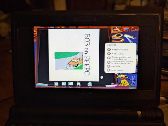 A picture on an EEEPC showing Microsoft Bob running "great greetings" with a greeting card that reads "BOB on EEEPC" the card has a picture of a car on it