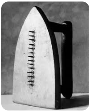 Man Ray's "The Gift (1921). Iron with metal nails down the middle sticking out.