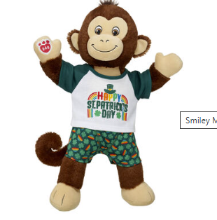 A cheeky chappy of a cuddly monkey. It is wearing fancy green shorts and a white T shirt saying Happy St Patrick's Day