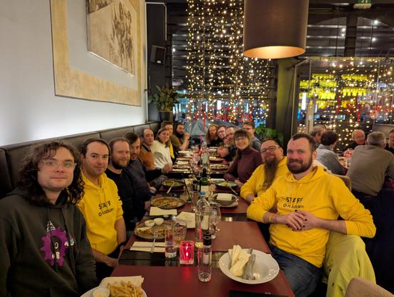 A group photo of FOSDEM staff having dinner.