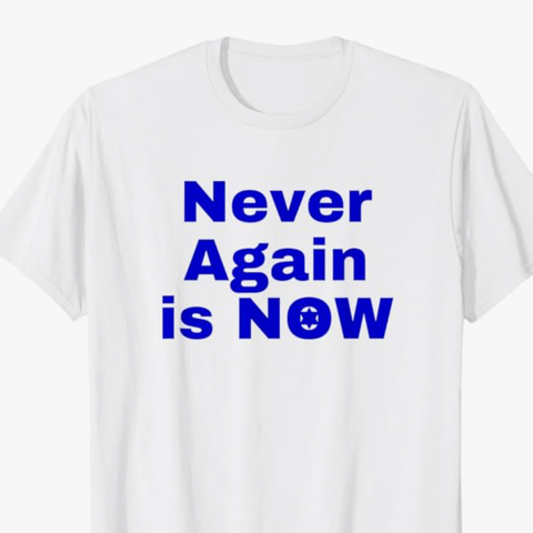 Never again is now is shown in blue lettering on a T shirt.