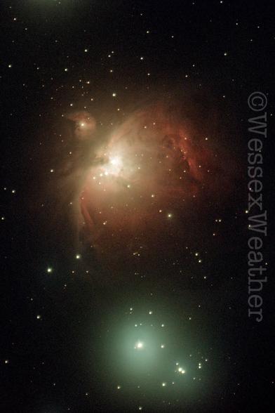 Messier 42 also known as the Orion Nebula a region of swirling red gases where stars are born. You can just see the three trapezium stars at its core.