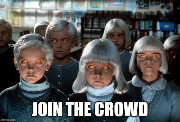 A screen shot from Village of the Damned. A group of school age children with matching grey cardigans, while turtle necks, red glowing eyes and white hair stare into the camera. The text says, JOIN THE CROWD.