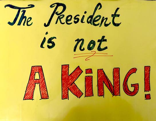 Handwritten sign saying, The President is not a king