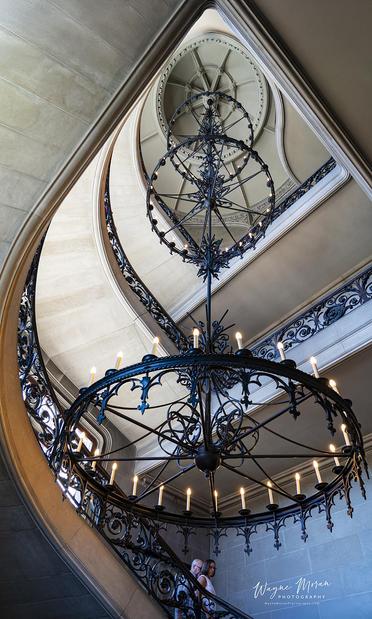 Grand Staircase and Chandelier at Biltmore Estate Ashville North Carolina

The Grand Staircase and Chandelier at Biltmore Estate: A Stunning Architectural Marvel

The Grand Staircase of the Biltmore Estate in Asheville, North Carolina, is one of the most breathtaking architectural elements of America’s largest private home. Designed by Richard Morris Hunt, this limestone spiral staircase gracefully winds its way upward in a stunning display of craftsmanship and elegance. Each step, carved from a single block of stone, is cantilevered from the wall, creating a floating effect that adds to the grandeur of the space.

At the heart of the staircase hangs the estate’s most iconic light fixture—a massive wrought-iron chandelier. This four-story, 1,700-pound masterpiece was crafted in the late 19th century and suspended from a single iron chain. Its design, a fusion of intricate scrollwork and Gothic-inspired details, perfectly complements the opulence of the surrounding space.



Image:
https://fineartamerica.com/featured/the-fine-art-of-the-grand-staircase-and-chandelier-at-biltmore-estate-ashville-north-carolina-wayne-moran.html

Read more:
https://waynemoranphotography.com/blog/exploring-the-biltmore-estate-ashville-north-carolina/

#GrandStaircase #Staircase #Stairs #Chandelier #fineArt #biltmore #historic #architecture #art #biltmoreestate #vanderbilt #ashville #northcarolina
#mountain #landscape