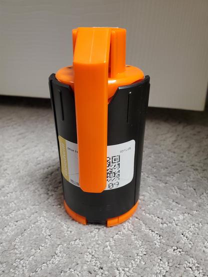 Orange and black "smoke hand grenade" looking toy that is actually a spring loaded "grenade" for nerf / airsoft / or gel balls