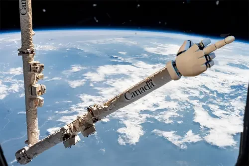 iss canadarm is a robotic arm of the internat. space station. canada written on it, modified to show a robot hand that shows "the finger"