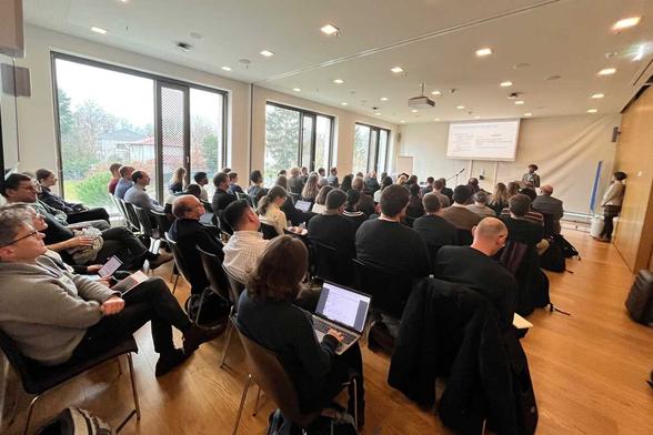 About 60 people sit together and listen to a lecture at a Workshop about LLMs in Scientific Publishing