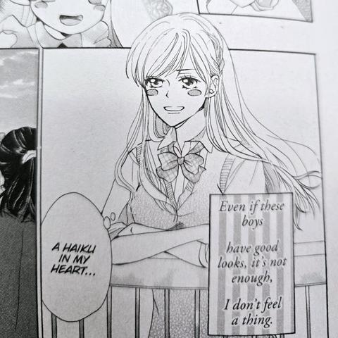 A photograph of the interior of Primitive Boyfriend, Volume 1. The image shows a pensive teenage girl deep in thought thinking to herself in haiku "in her heart" as she says in a thought bubble. The haiku reads, "Even if these boys / have good looks, it's not enough, / I don't feel a thing."