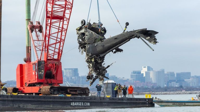 Wreckage from. a mid-air collision being pulled out of a river