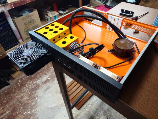 A 2U server; a radiator from a 240 NXZT AIO extrudes from the drive bay, fan and grill on top.